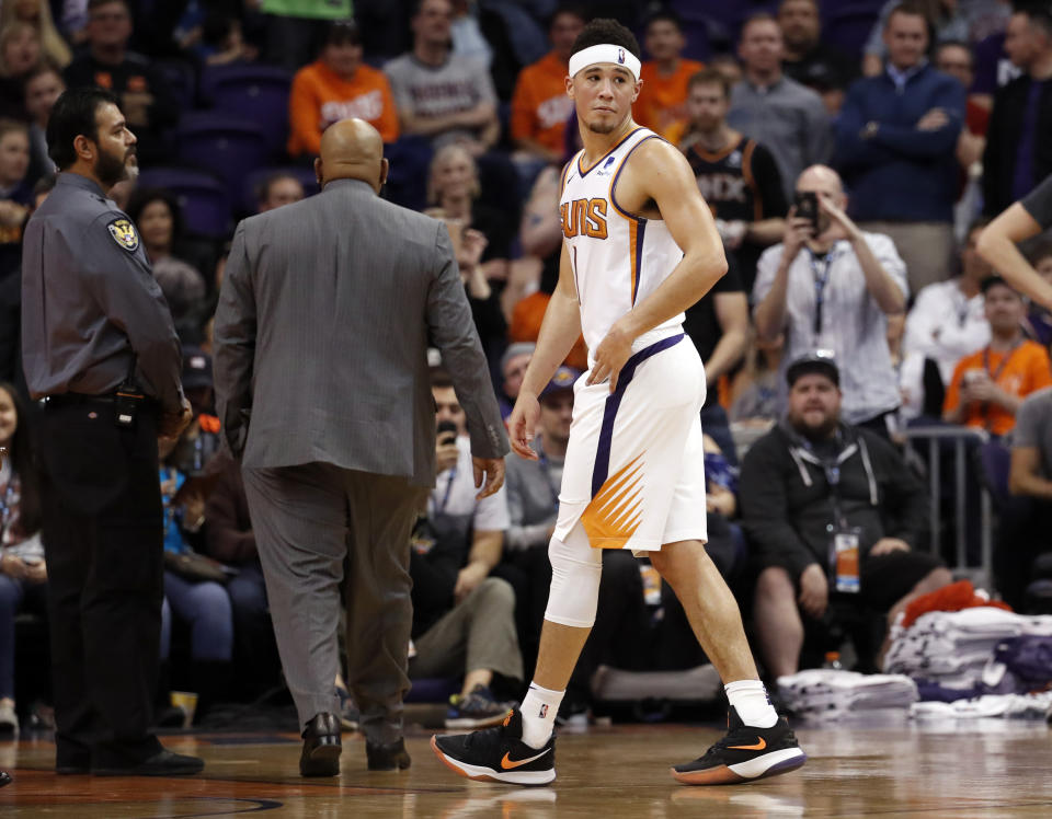 Devin Booker wasn’t happy after getting into it with Gorgui Dieng on Tuesday. (AP Photo/Matt York)