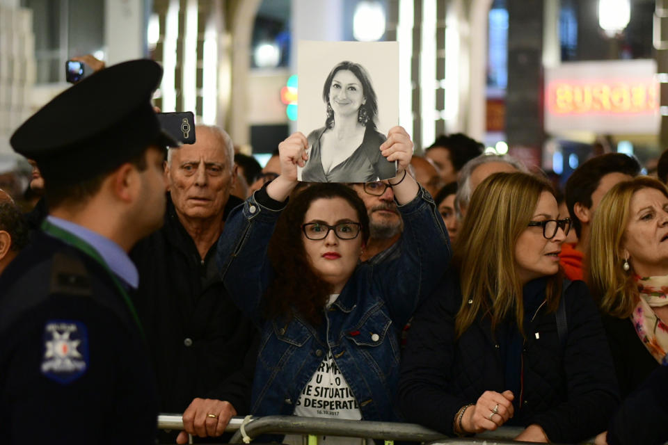 A protestors holds up a pictures of slain journalist Daphne Caruana Galizia during a demonstration outside Malta's prime minister's office in Valletta, Malta, Wednesday, Nov. 27, 2019. On Wednesday Maltese police arrested Prime Minister Joseph Muscat’s former chief of staff Keith Schembri for questioning as a person of interest in the murder of journalist Daphne Caruana Galizia. (AP Photo/Str)