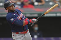 Minnesota Twins' Nelson Cruz (23) hits a two RBI single in the second inning of a baseball game against the Cleveland Indians, Wednesday, April 28, 2021, in Cleveland. (AP Photo/David Dermer)