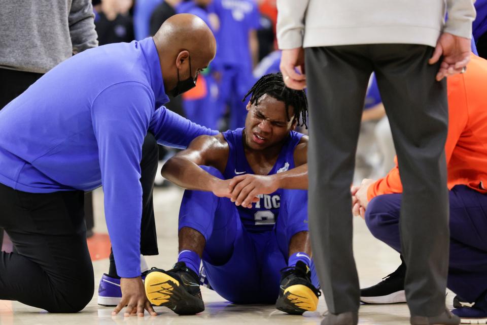 Kentucky guard Sahvir Wheeler (2) is tended to after suffering an injury during the second half of an NCAA college basketball game against Auburn Saturday, Jan. 22, 2022, in Auburn, Ala.