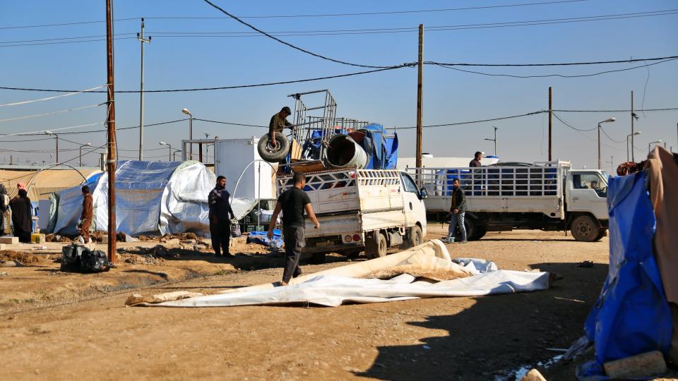 Displaced Iraqis pack up in preparation to return to their homes in Jadah 5 camp in northern Iraq, Thursday, Feb. 4, 2021. Iraq appears to have back-tracked plans to close a camp for internally-displaced Iraqis, many with links to the Islamic State, following a week of confusion and outcry from families unable to return home. (AP Photo/Farid Abdulwahed)