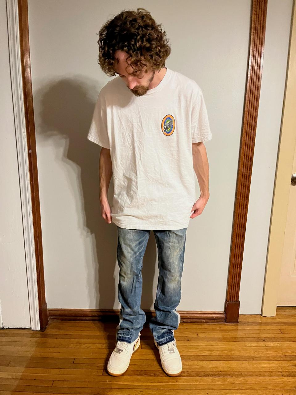 Trevor Rapoport wearing his customized denim jeans, button-down shirt and brown pants. People interested in learning to upcycle their own clothing can take a fashion course, attend local art store classes or even watch videos on YouTube.