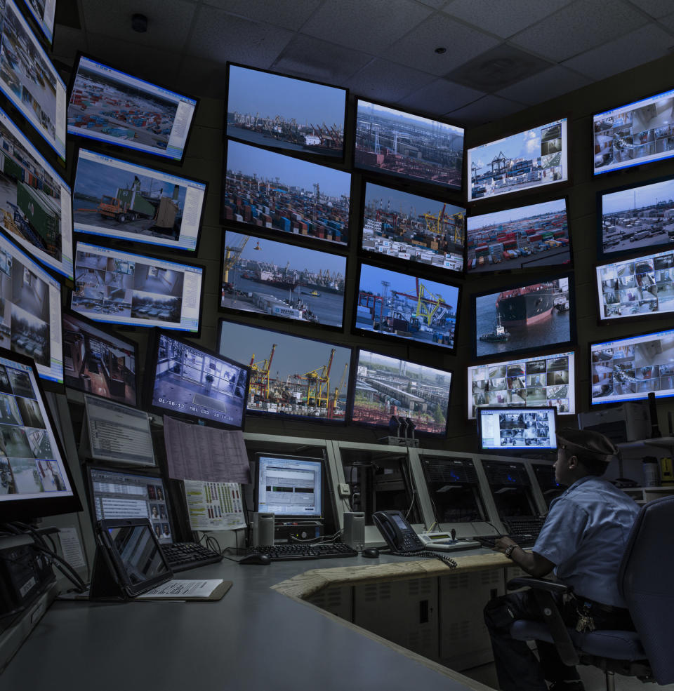 A security room with lots of screens