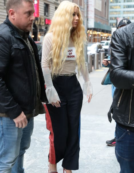 Iggy Azalea wore a crop top and Tommy Hilfiger leggings as she arrives to  the set