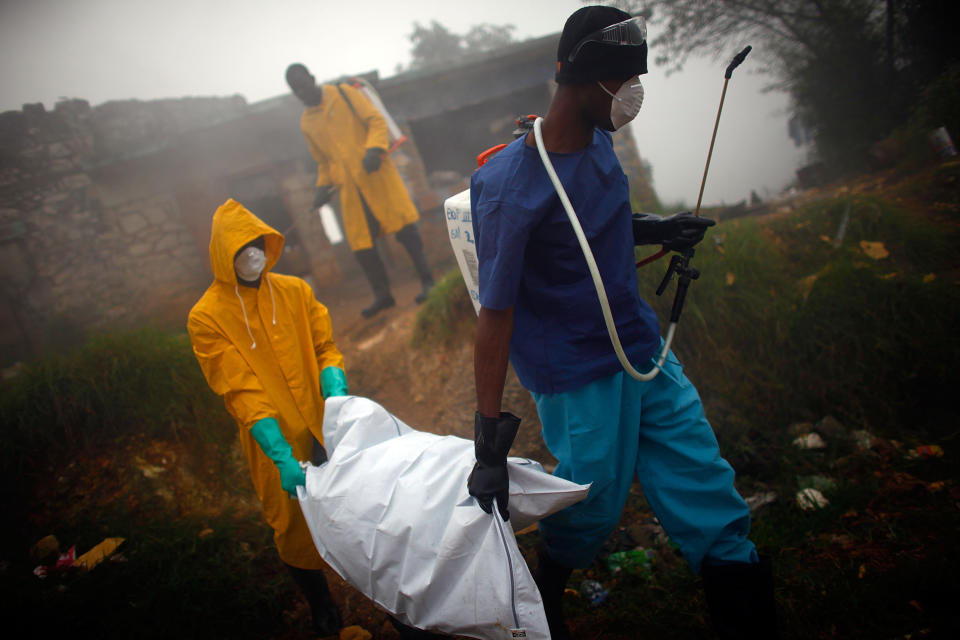 Health workers collect the body of a cholera victim in Petionville, Haiti, in February 2011. The disease first appeared on the island in October 2010, likely introduced by U.N. peacekeepers from Nepal, possibly a single individual.