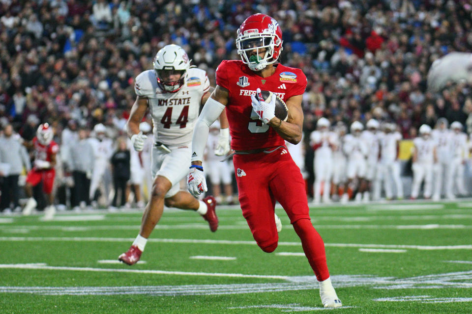 ALBUQUERQUE, NEW MEXICO - DECEMBER 16: Wide receiver Jaelen Gill #5 of the Fresno State Bulldogs runs for yards after catching a pass against linebacker Keyshaun Elliott #44 of the New Mexico State Aggies during the first half of the Isleta New Mexico Bowl at University Stadium on December 16, 2023 in Albuquerque, New Mexico. (Photo by Sam Wasson/Getty Images)