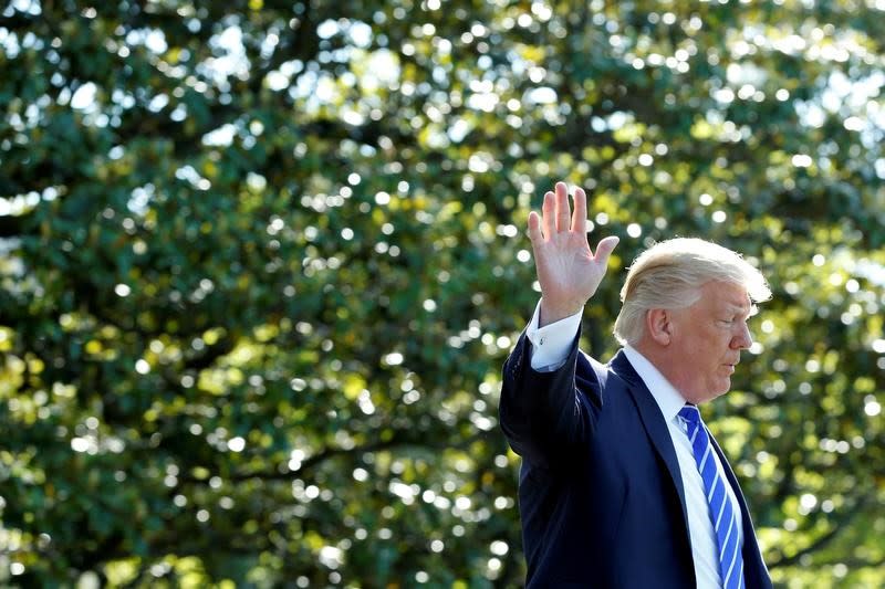 FILE PHOTO: U.S. President Donald Trump waves as he walks on the South Lawn of the White House in Washington, U.S., before his departure to Groton, Connecticut, May 17, 2017. REUTERS/Yuri Gripas/File Photo