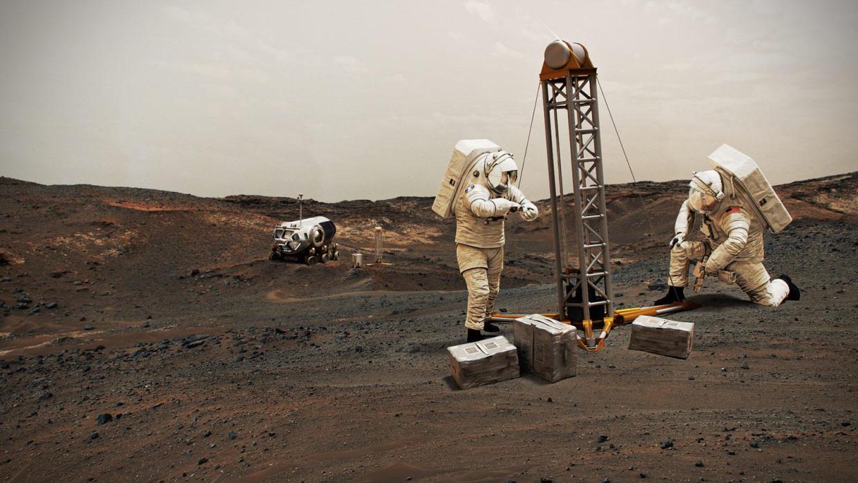  Illustration of two astronauts in white spacesuits drilling for water ice on the surface of mars. 