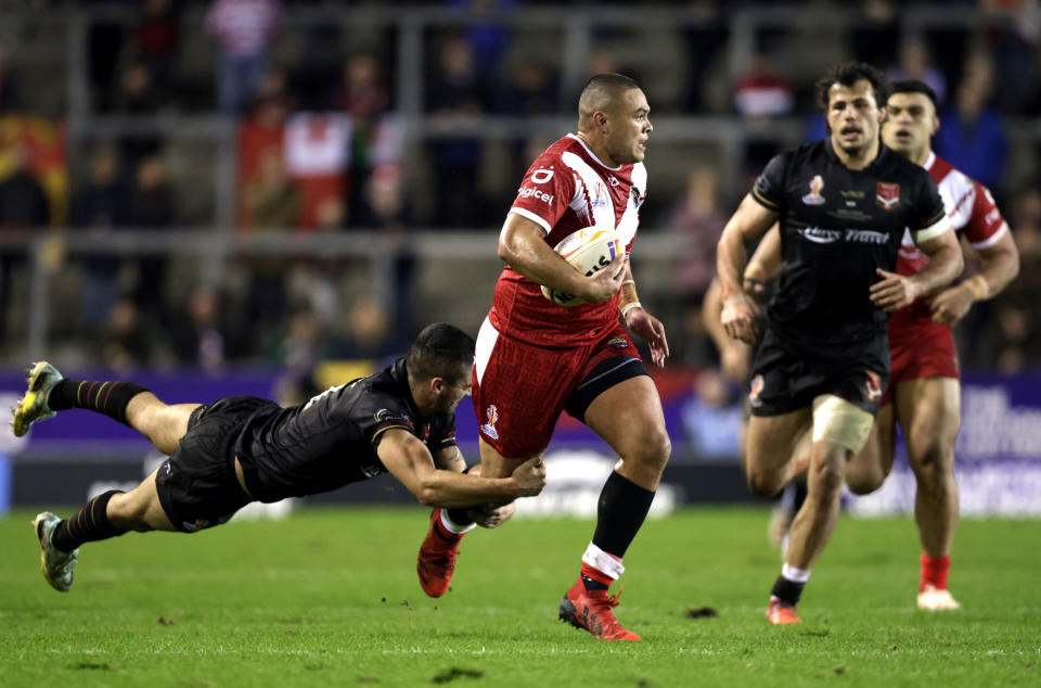 Tonga's Tui Lolohea attempts to break away during the Rugby League World Cup group D match between Wales and Tonga at the Totally Wicked Stadium, St Helens, England, Monday Oct. 24, 2022. (Richard Sellers/PA via AP)