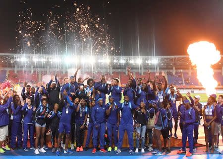 Apr 23, 2017; Nassau, Bahamas; Members of the United States team and captains LaShawn Merritt and Natasha Hastings pose with the golden baton award for the overall championship of the IAAF World Relays at Thomas A. Robinson Stadium. Mandatory Credit: Kirby Lee-USA TODAY Sports