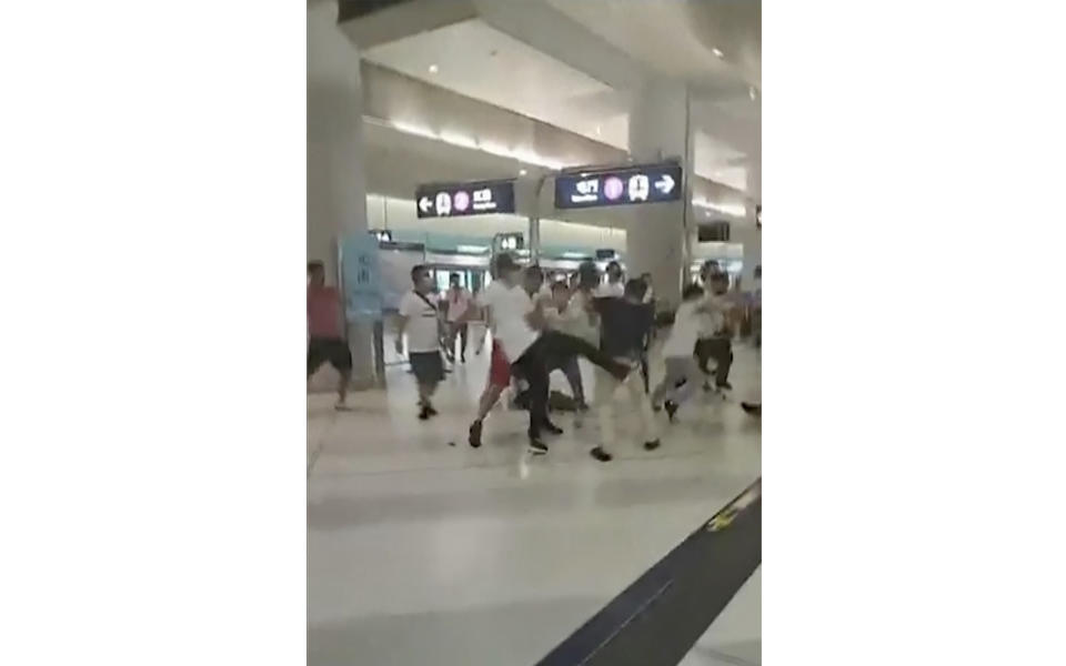 This image taken from a video shows confrontation between masked assailants and protesters at Yuen Long MTR train station in Hong Kong on July 21, 2019. | Lam Cheuk-ting—AP