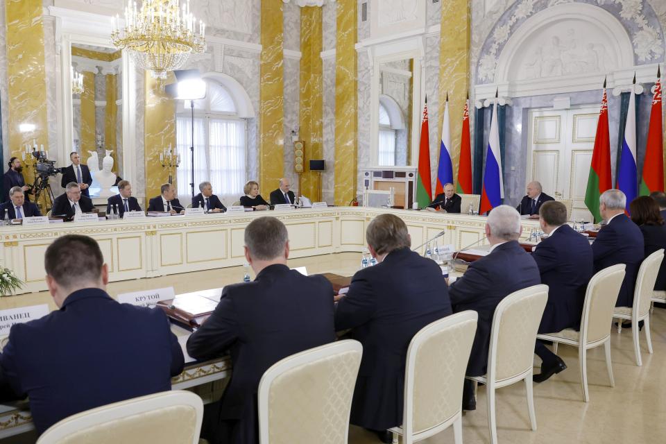 Russian President Vladimir Putin, background second right, and Belarus President Alexander Lukashenko, background right, attend a meeting of the Union State Supreme Council in St. Petersburg, Russia, Monday, Jan. 29, 2024. (Dmitry Astakhov, Sputnik, Government Pool Photo via AP)