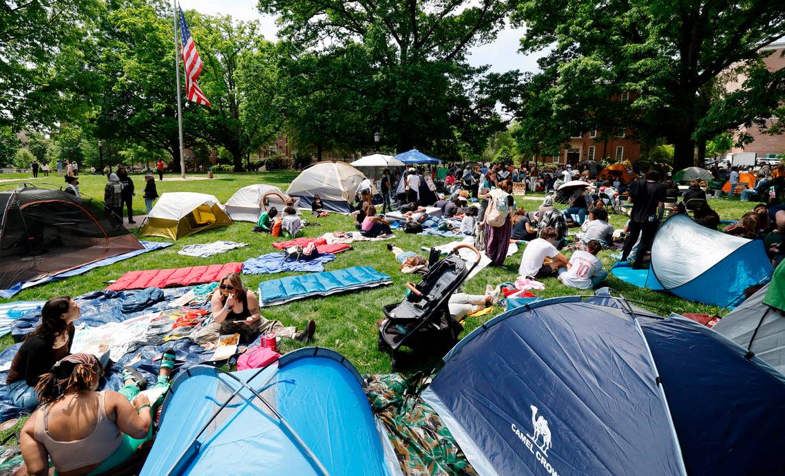 Protesters gather amongst their tents as part of a Gaza Solidarity Encampment at Polk Place on the campus of UNC-Chapel Hill on Friday afternoon, April 26, 2024. Ethan Hyman/ehyman@newsobserver.com