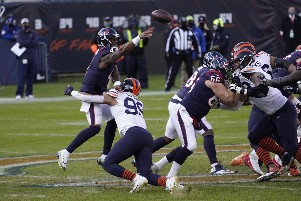Houston Texans quarterback Deshaun Watson (4) throws as he is hit by Chicago Bears' Trevis Gipson (99) during the second half of an NFL football game, Sunday, Dec. 13, 2020, in Chicago. (AP Photo/Charles Rex Arbogast)