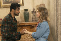 This image released by CBS shows Utkarsh Ambudkar, left, and Rose McIver in a scene from the comedy series "Ghosts." (Cliff Lipson/CBS via AP)