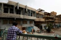 A member of a first response team tours the courtyard of the National Hospital in the northern Syria city of Raqa on October 13, 2018