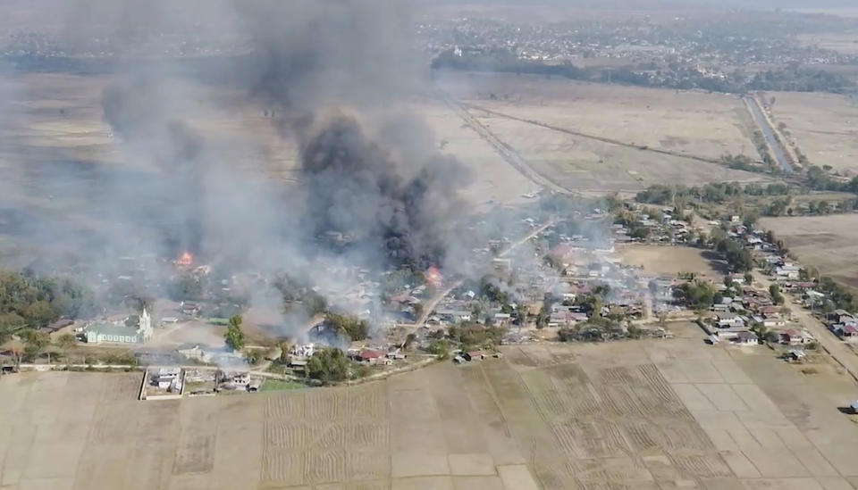 In this image taken from drone video provided by Free Burma Rangers, black smoke arises from burning buildings in Waraisuplia village in Kayah State, Myanmar on Feb. 18, 2022. While Russia’s war in Ukraine dominates global attention, Myanmar’s military is targeting civilians in air and ground attacks on a scale unmatched in the country since World War II, according to a longtime relief worker who spent almost three months in a combat zone in the Southeast Asian nation. (Free Burma Rangers via AP)