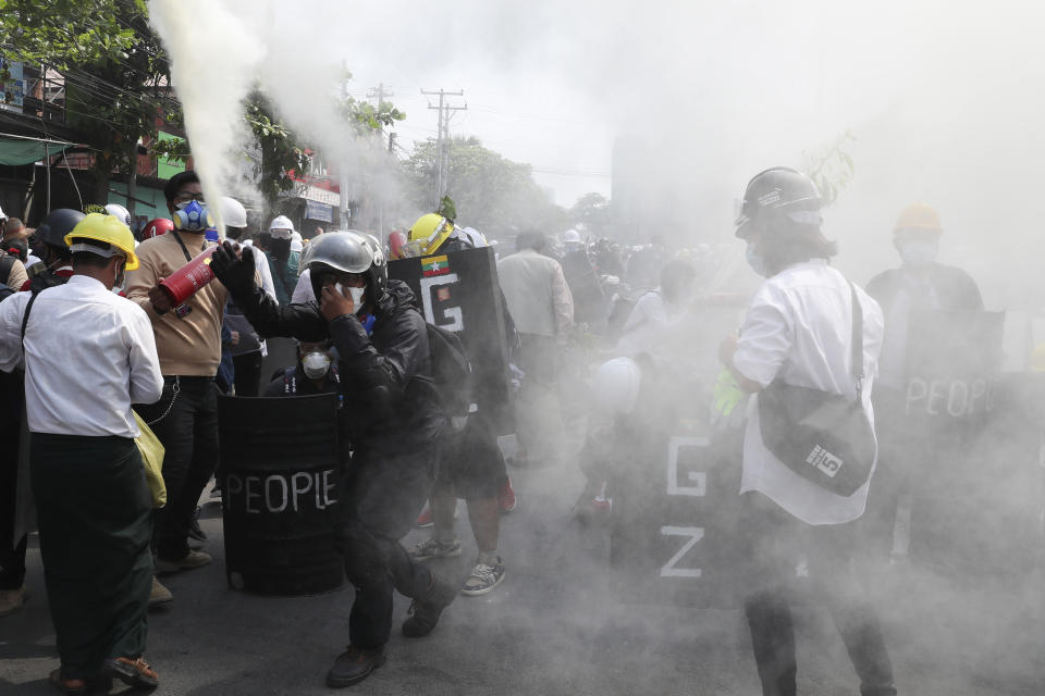 FILE - In this March 7, 2021, file photo, anti-coup protesters discharge fire extinguishers to counter the impact of the tear gas fired by police during a demonstration in Mandalay, Myanmar. One hundred days since their takeover, Myanmar’s ruling generals maintain just the pretense of control over the country. There are fears the military takeover is turning Myanmar into a failed state. (AP Photo, File)