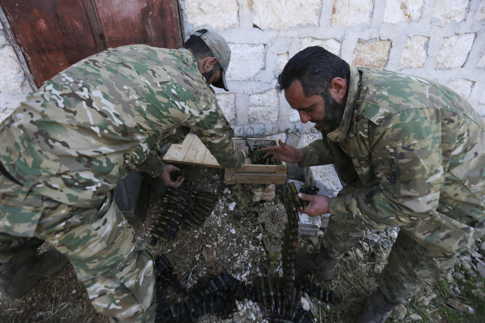 Turkish backed rebel fighters prepare for an attack near the village of Neirab in Idlib province, Syria, Thursday, Feb. 20, 2020. Two Turkish soldiers were killed Thursday by an airstrike in northwestern Syria, according to Turkey's Defense Ministry, following a large-scale attack by Ankara-backed opposition forces that targeted Syrian government troops. (AP Photo/Ghaith Alsayed)