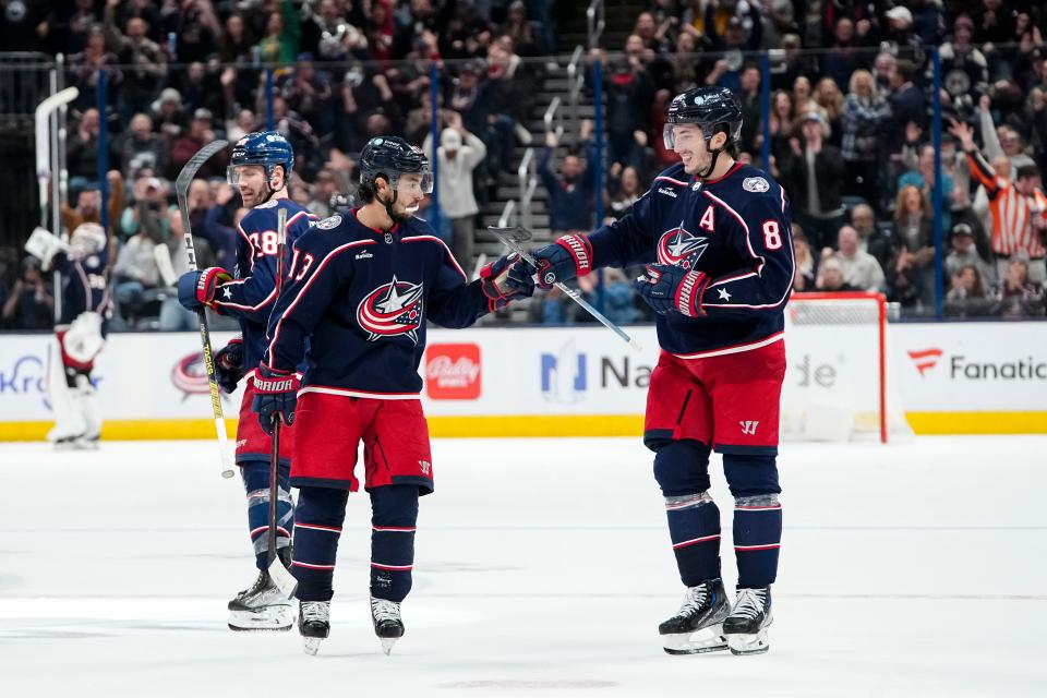 Oct 20, 2023; Columbus, Ohio, USA; Columbus Blue Jackets left wing Johnny Gaudreau (13) congratulates defenseman Zach Werenski (8) on scoring an empty net goal during the third period of the NHL hockey game against the Calgary Flames at Nationwide Arena. The Blue Jackets on 3-1.
