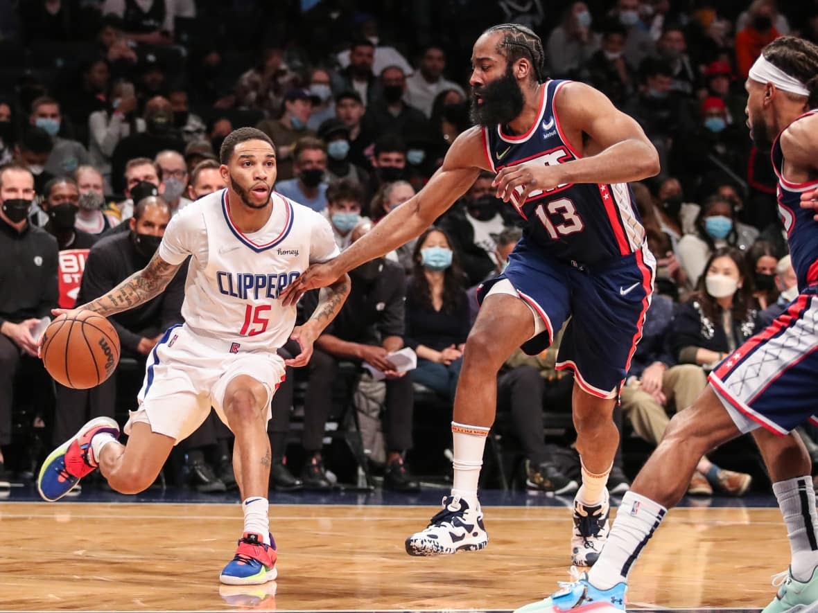 Los Angeles Clippers guard Xavier Moon (15) is guarded by Nets guard James Harden (13) in an NBA game in January in Brooklyn, N.Y. Moon spent three seasons playing for the Edmonton Stingers in the CEBL before signing with the Clippers in 2021. (Wendell Cruz/USA Today Sports - image credit)