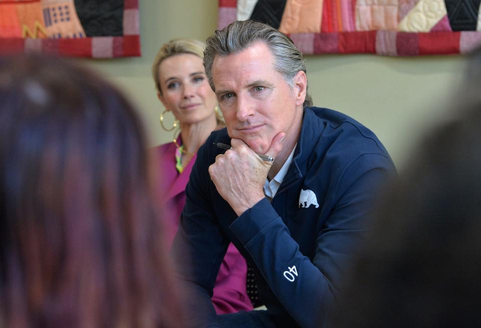 California Gov. Gavin Newsom and First Partner Jennifer Newsom, listen to students from New College of Florida on Wednesday during Newsom's stop at the Betty J. Johnson North Sarasota Public Library in Sarasota. 