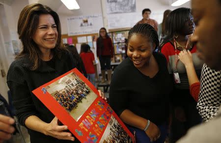 Opera singer Ana Maria Martinez (L) receives a gift from students at Lake View High School in Chicago, Illinois, October 22, 2014. REUTERS/Jim Young