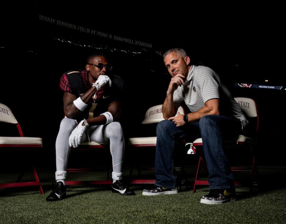 Florida State commit Charles Lester III poses with head coach Mike Norvell during his official visit in June 2023.