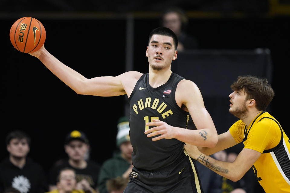 Purdue center Zach Edey (15) catches a pass over Iowa forward Owen Freeman (32) during the second half of an NCAA college basketball game, Saturday, Jan. 20, 2024, in Iowa City, Iowa. Purdue won 84-70. (AP Photo/Charlie Neibergall)