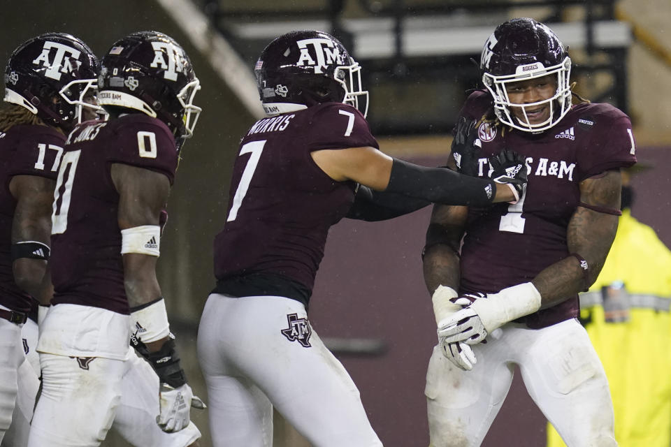 Texas A&M linebacker Buddy Johnson (1) reacts with teammates after he intercepted a pass from LSU and returned it for a touchdown during the third quarter of an NCAA college football game, Saturday, Nov. 28, 2020, in College Station, Texas. (AP Photo/Sam Craft)