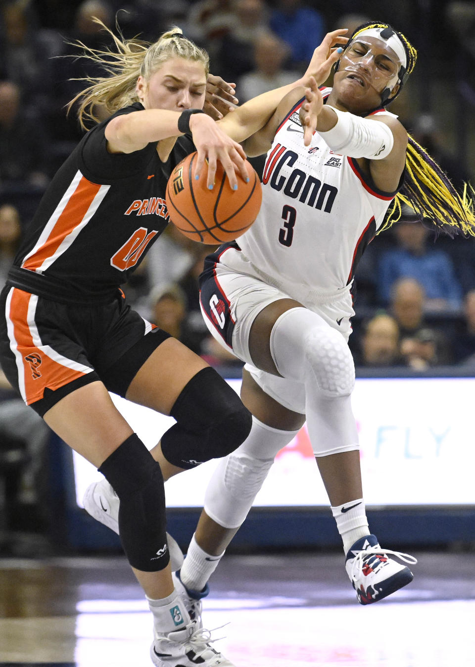 UConn's Aaliyah Edwards (3) fouls Princeton's Ellie Mitchell (00) during the first half of an NCAA college basketball game Thursday, Dec. 8, 2022, in Storrs, Conn. (AP Photo/Jessica Hill)