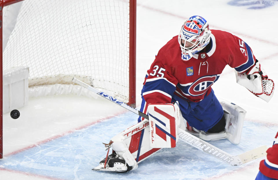 Montreal Canadiens goaltender Sam Montembeault is scored on by Calgary Flames' Nazem Kadri during the second period of an NHL hockey match in Montreal, Quebec, Tuesday, Nov. 14, 2023. (Graham Hughes/The Canadian Press via AP)