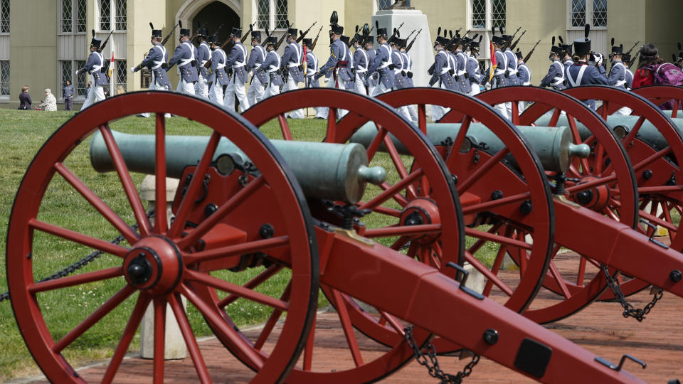 Virginia Military Institute Corp of Cadets march out of the barracks past cannons during a change of command parade and ceremony on the parade grounds at the school in Lexington, Va., Friday, May 14, 2021. Kasey Meredith was installed as the first female to lead the Virginia Military Institute's Corps of Cadets in its 182 year history. (AP Photo/Steve Helber)