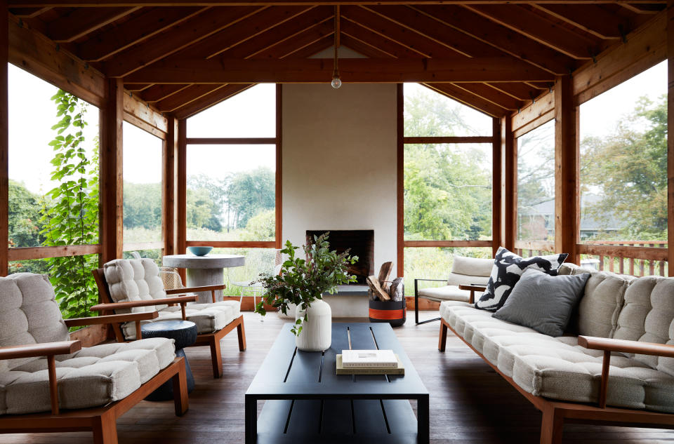 a large screen in porch with modern furniture