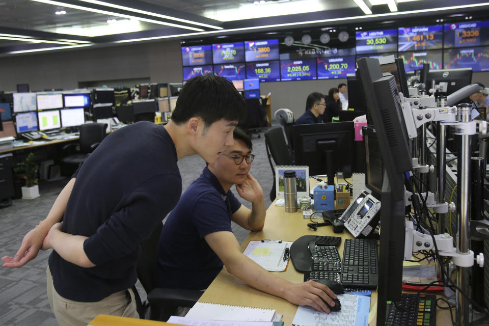 Currency traders watch monitors at the foreign exchange dealing room of the KEB Hana Bank headquarters in Seoul, South Korea, Friday, Oct. 4, 2019. Asian stocks were mixed Friday after Wall Street rebounded on investor hopes for a U.S. interest rate cut. (AP Photo/Ahn Young-joon)