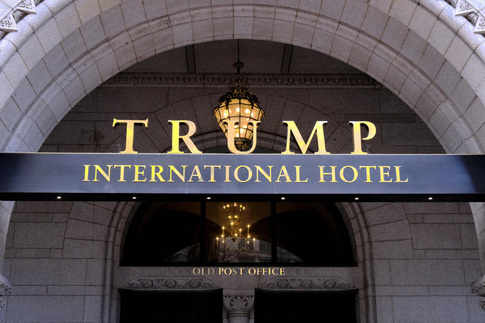 FILE - This March 11, 2019 file photo, shows the north entrance of the Trump International in Washington. A financial disclosure report released Friday, July 31, 2020, shows that revenue at President Donald Trump’s Washington D.C. hotel and several of his biggest clubs and resorts mostly held steady last year before the coronavirus forced many to shut their doors and lay off workers. (AP Photo/Mark Tenally, File)