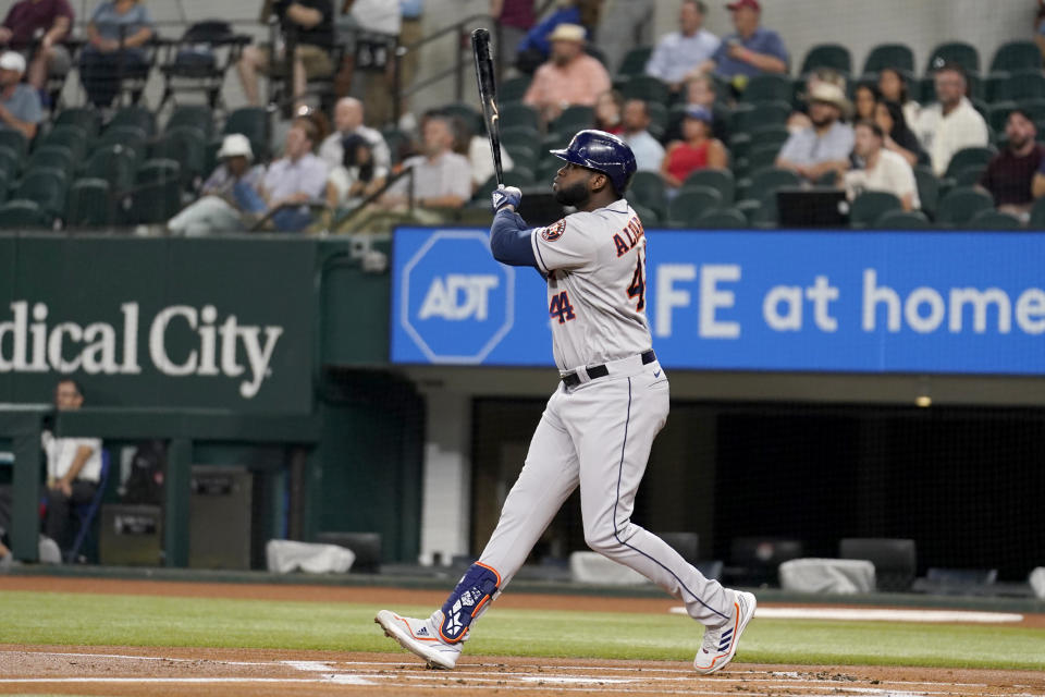 Houston Astros' Yordan Alvarez watches the flight of his two-run home run ball that scored Jeremy Pena in the first inning of a baseball game against the Texas Rangers, Wednesday, Sept. 6, 2023, in Arlington, Texas. (AP Photo/Tony Gutierrez)