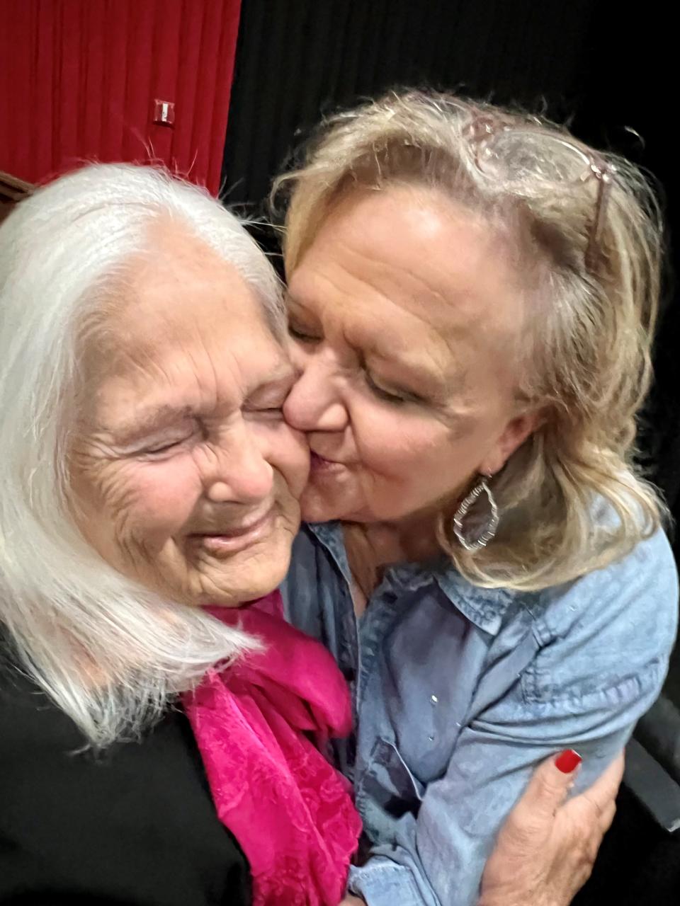 Christian comedian Chonda Pierce, right, kisses Joyce Mayo, her former drama teacher at Cheatham County High School, at the premiere of Pierce's dramedy movie, "Roll With It," at the Regal Green Hills theaters in Nashville May 9, 2023