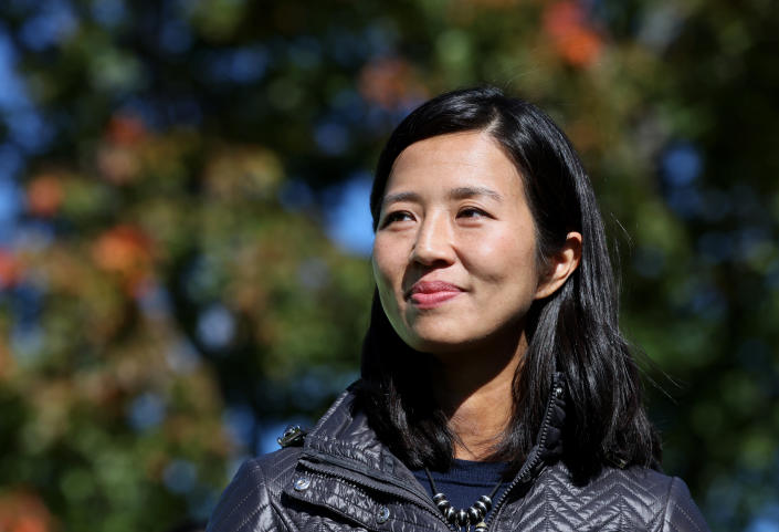 Michelle Wu listens to a speaker at a climate rally in Boston.