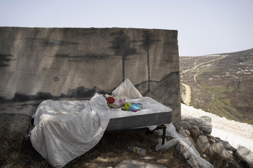 A bed in the West Bank settlement outpost of Homesh, Thursday, Aug. 31, 2023. "Our government has finally figured out that withdrawing from land is a prize for terror," said Rabbi Menachem Ben Shachar, a teacher at the newly built yeshiva seminary at Homesh, one of four symbolically important West Bank outposts that Israel evacuated in 2005 together with settlements in Gaza. Lawmakers repealed the legislation this year that had barred Israeli settlers from visiting the sites, which either sit on or impede access to private Palestinian land. (AP Photo/Maya Alleruzzo)