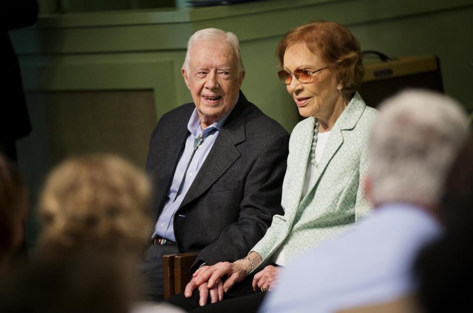 Former President Jimmy Carter, left, sits with his wife Rosalynn as they pose for photos after Carter taught Sunday School class at Maranatha Baptist Church in his hometown on Aug. 23, 2015, in Plains, Ga. (AP Photo/David Goldman)