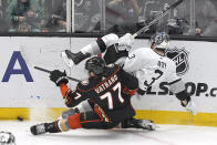Anaheim Ducks right wing Frank Vatrano, left, and Los Angeles Kings defenseman Matt Roy collide during the third period of an NHL hockey game Saturday, April 13, 2024, in Los Angeles. (AP Photo/Mark J. Terrill)