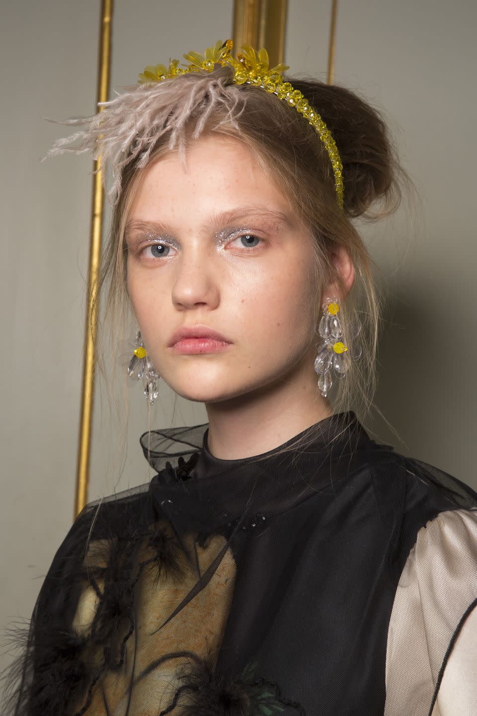 <p>You can make a dramatic hair accessory and glittery eye makeup look a little more romantic by pulling-out a few face-framing fuzzy pieces. </p>