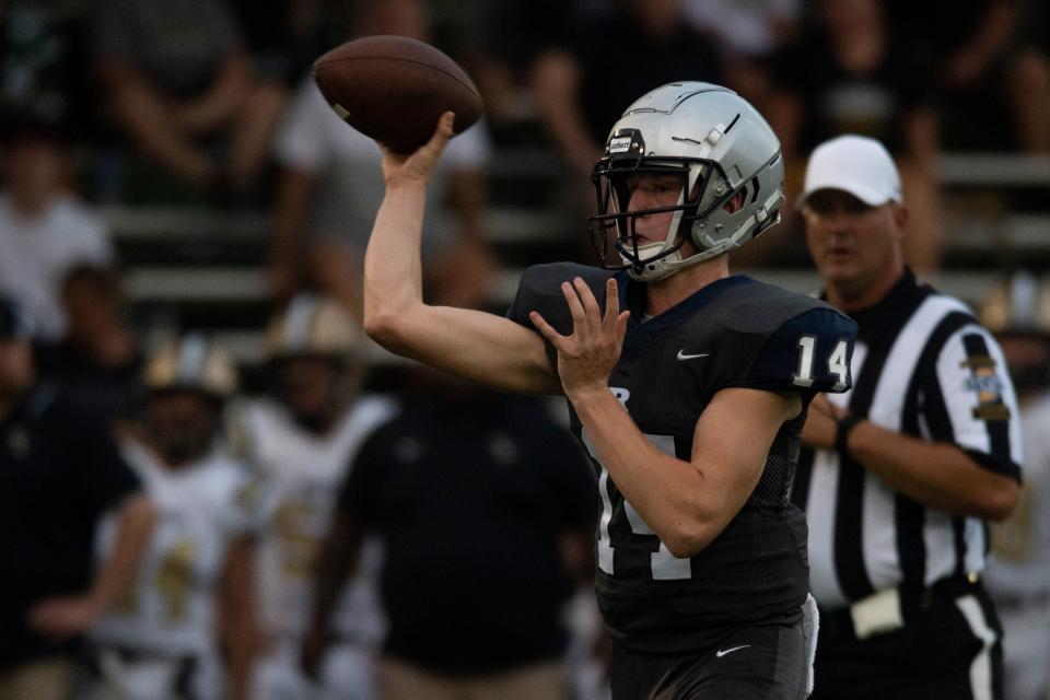 Reitz’s Ben Davies (14) passes as the Reitz Panthers play the Jasper Wildcats at the Reitz Bowl in Evansville, Ind., Friday evening, Sept. 2, 2022. 