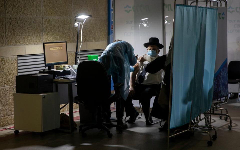 An ultra-Orthodox Jewish man receives a Pfizer COVID-19 coronavirus vaccine in Israel  - AP