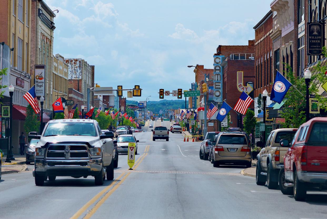 Bristol, Virginia and Bristol, Tennessee / USA - July 19, 2018: A pickup truck travels toward the camera on the Tennessee side of State Street in the separated cities of Bristol, Tennessee (l), and Bristol, Virginia (r).
