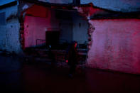 <p>A elderly woman walks in front of a damaged house in the town of Mandra western Athens, on Friday , Nov. 17, 2017. (Photo: Petros Giannakouris/AP) </p>