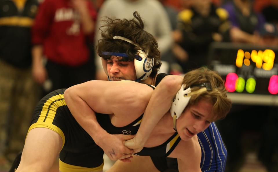 Oldham County’s  Miller Brown makes a move on Woodford County’s Issac Johns.Feb. 11, 2023