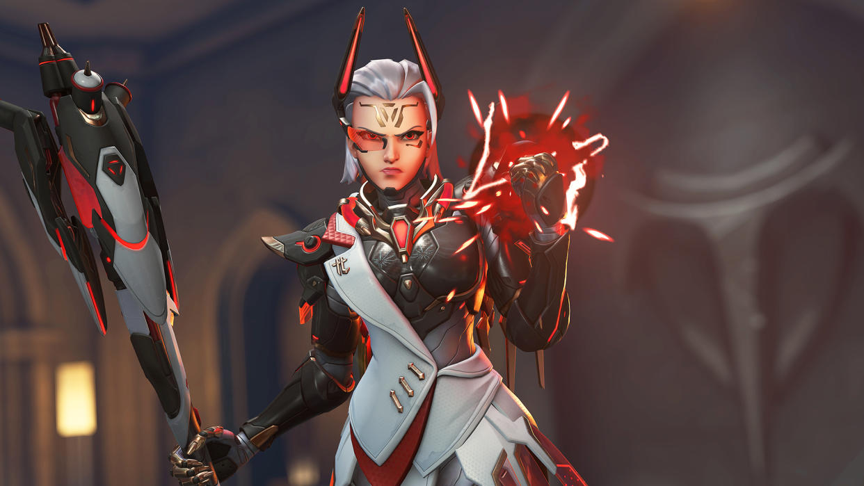  Overwatch 2 character Mercy wearing new red and black Talon mythic skin clenching her fist. 