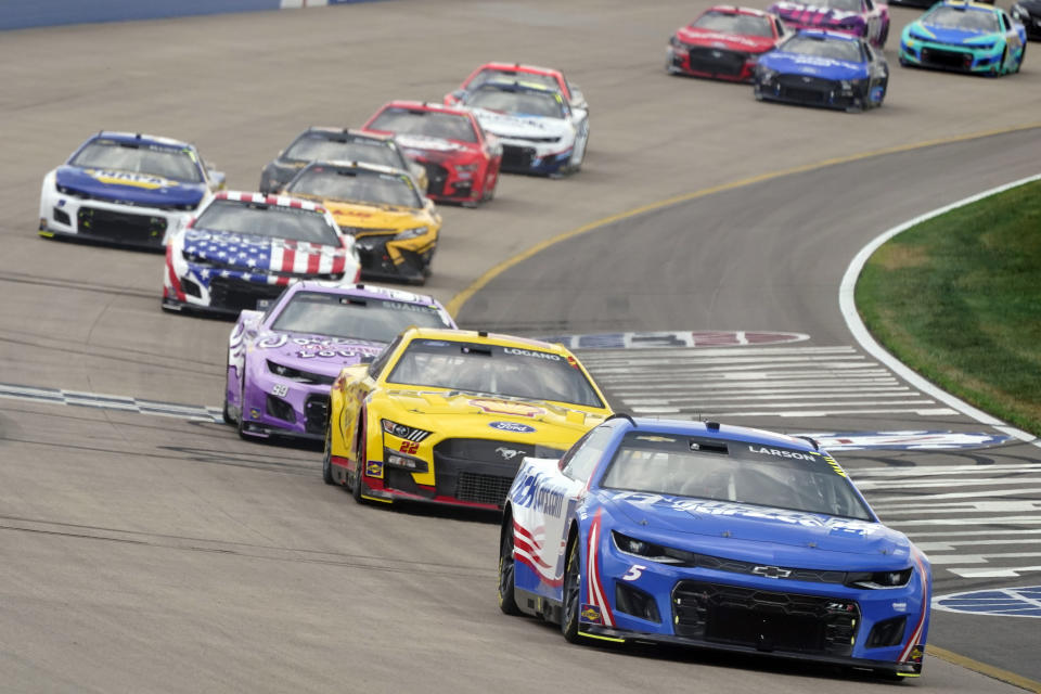 Kyle Larson (5) leads a group through a turn during a NASCAR Cup Series auto race Sunday, June 26, 2022, in Lebanon, Tenn. (AP Photo/Mark Humphrey)